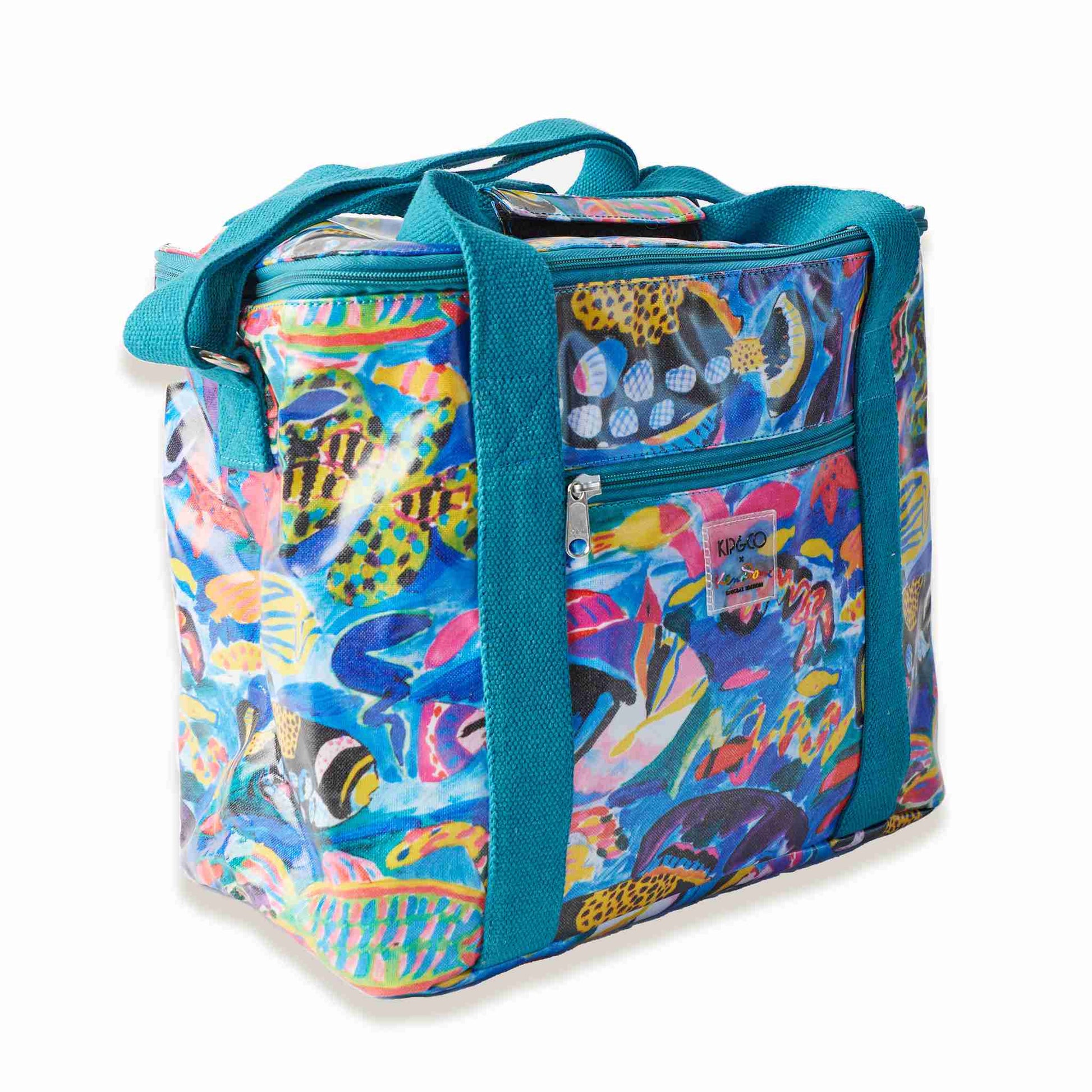 Featuring a super-coloured underwater oasis of assorted tropical reef fish with teal green zip detail and woven carry handles, the Kip&Co X Ken Done Barrier Reef Garden Cooler Bag showcases artwork from Australian art icon Ken Done. Available in store and online at Kip & Co stockist Not Plain Jane