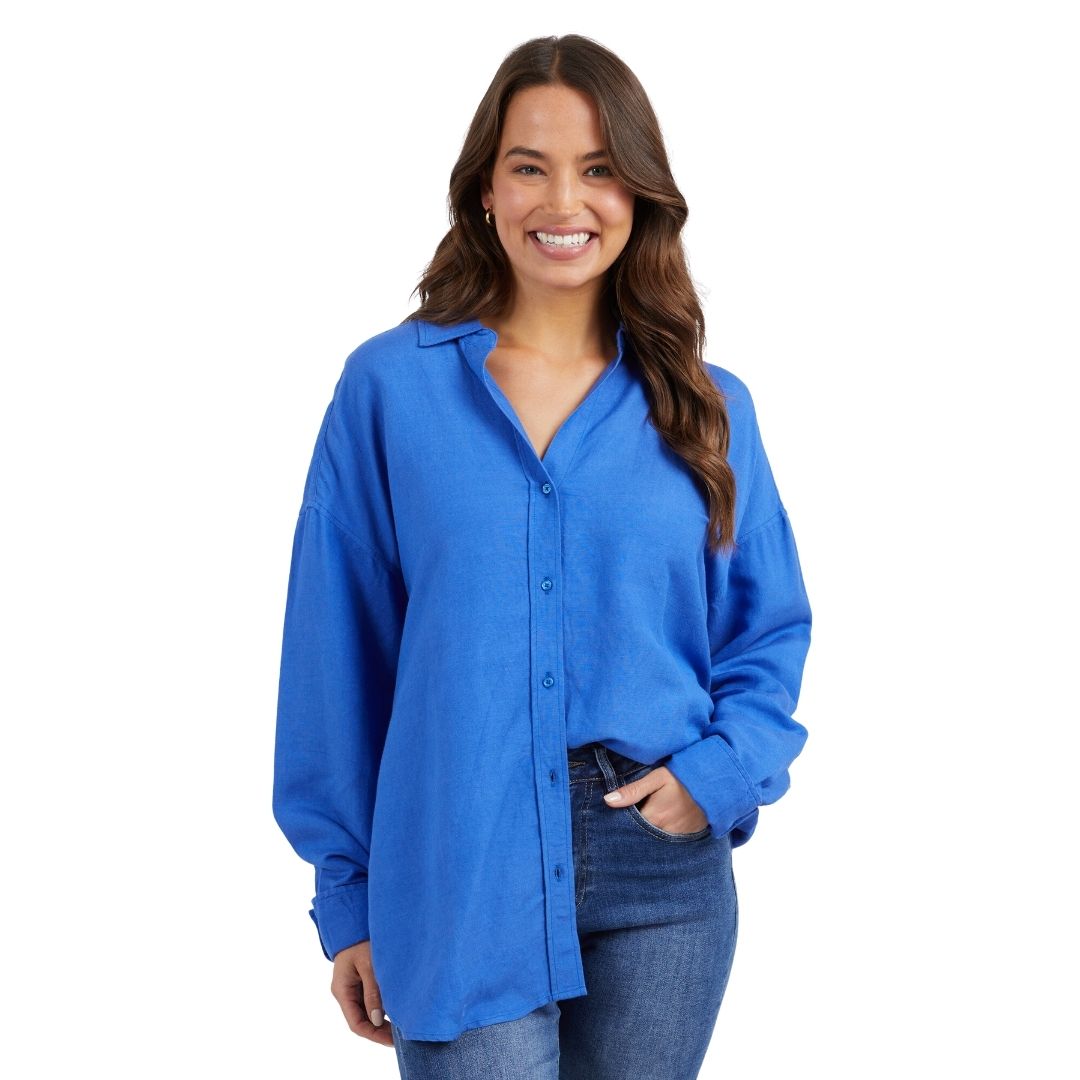 The Cordelia Linen Shirt in royal blue is a classic shirt featuring a V-neckline with buttons starting from the bust.
