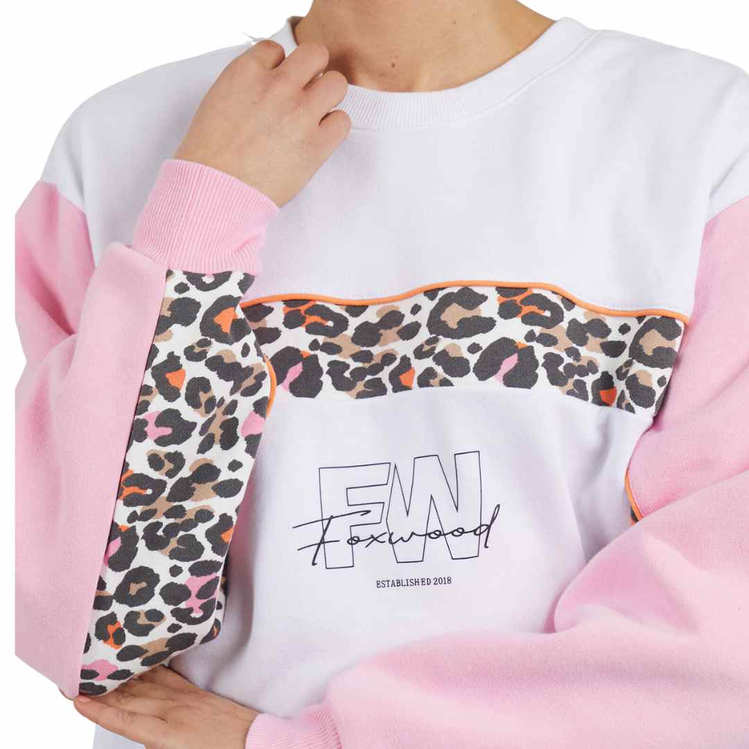 The Leopard crew from the Foxwood Leisure collection is a white crew with pink sleeves featuring a pop of leopard print across the chest and inside of the sleeves