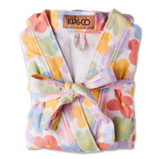 The Paper Daisy Printed Terry Bath Robe features sweet and simple daisies in a rainbow of colours on a white base.