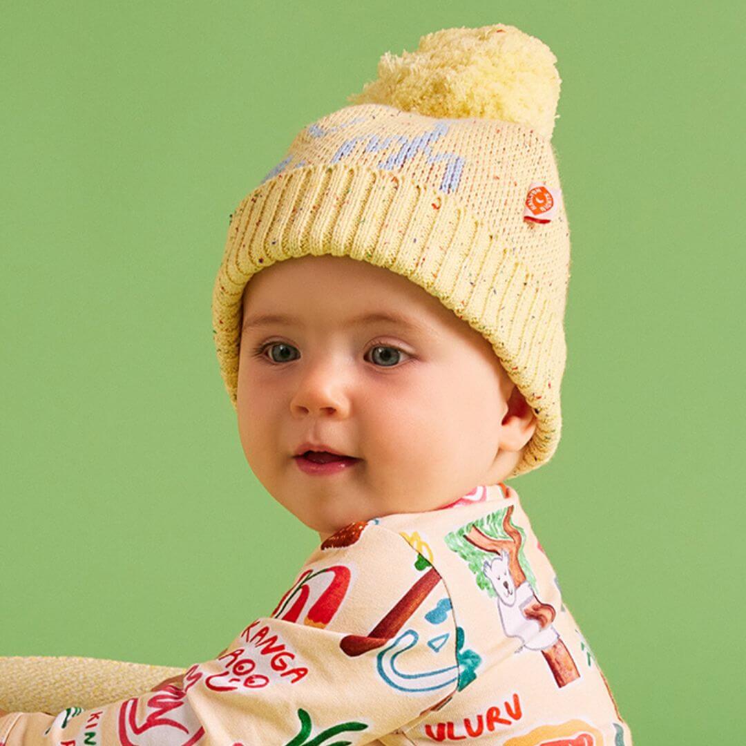 Halcyon Nights Sunny koala knit beanie is a super cute yellow machine washable beanie featuring a super cute pale blue koala print and coo-ee! on the back.