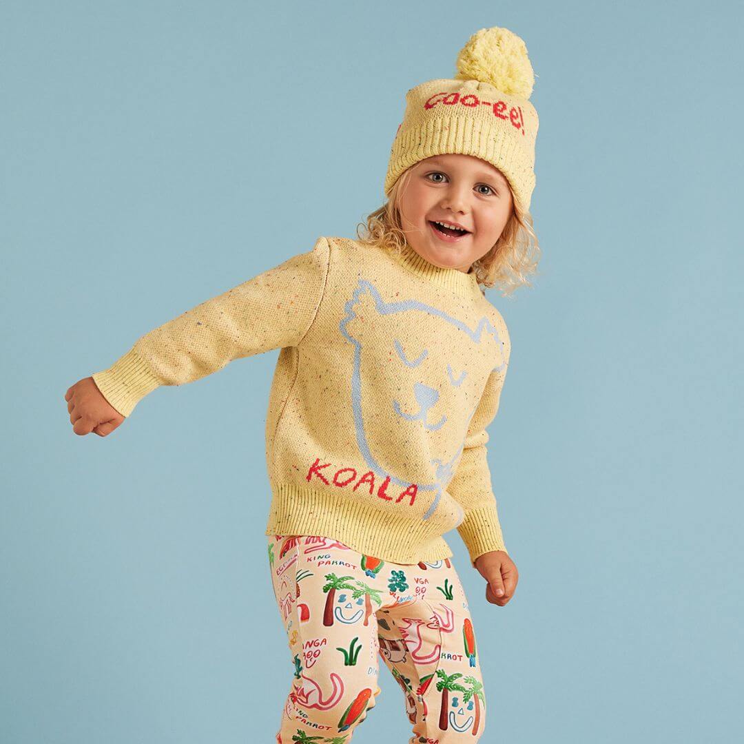 Halcyon Nights Sunny koala knit beanie is a super cute yellow machine washable beanie featuring a super cute pale blue koala print and coo-ee! on the back.